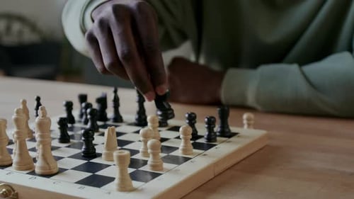 Adult Moves Chess Piece on Chessboard Game