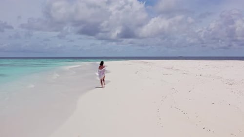 Girl Running on White Sand in the Maldives