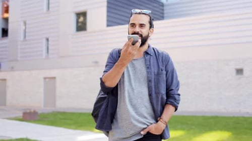 Man Using Voice Assistant App While Walking Outside