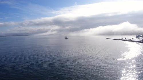 Vintage ship glides across the calm waters of monterey bay California seen by drone