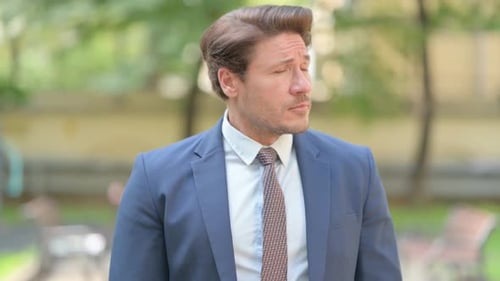 Man In Suit Checks Watch Outside