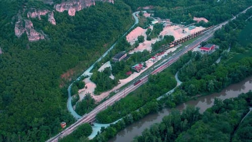 A train with wagons rides on rails. Aerial drone shot over railway. Aerial view of railroad with tra