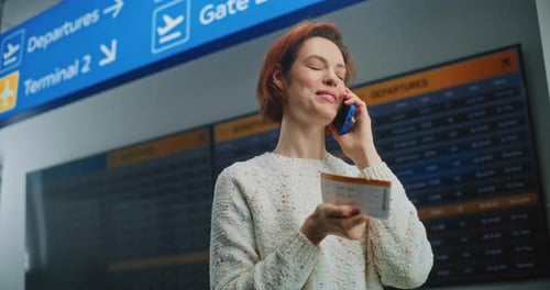Airport Terminal Woman Holding Plane Ticket Talking By Phone to Check Information