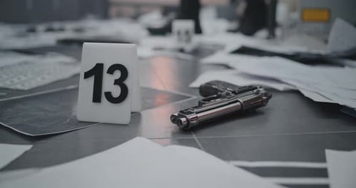 Evidence Marker and Silver Gun at Crime Scene