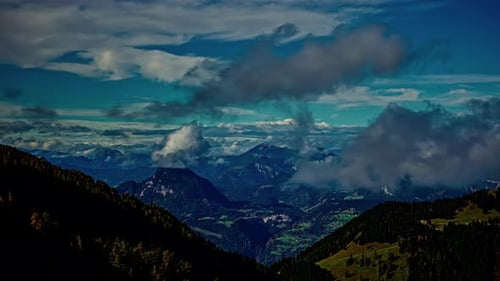 Blue hour timelapse from mountain peak, valley covered in sunshine