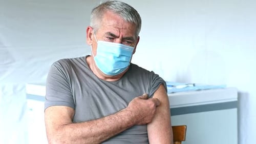 Elderly Man in Face Mask Getting Covid Vaccine Doctor Giving Injection to Senior Man at Hospital