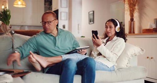 Tablet, notes and couple in home living room on sofa, streaming video and bonding
