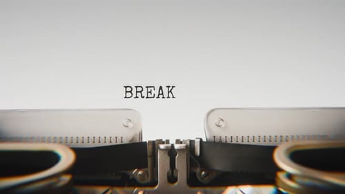 Old mechanical typewriter typing Breaking News in a close-up view.