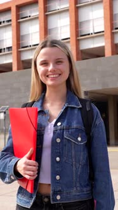 Happy Female University Student Standing Outside Campus Building