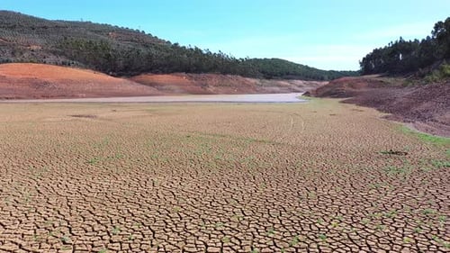 Aerial View Lake in the Background Large Area of Cracked Soil Due to Long Drought