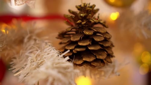 Golden Pine Cone on Christmas Tree with Lights