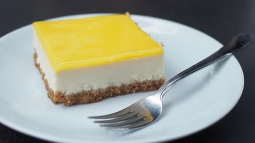 Slice of Cheesecake with Yellow Jelly on Plate