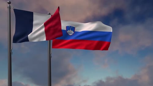 France and Slovenia National Flags Waving Against Cloudy Sky
