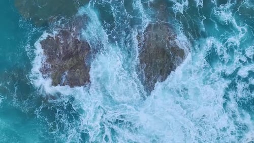 Aerial View Waves Crashing Into Rocky Cliffs at Sunrise Stormy Sea Textures