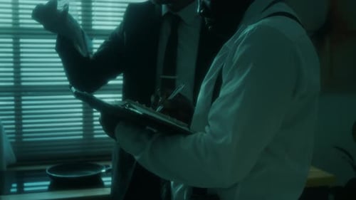 Detectives Examining Evidence at Crime Scene