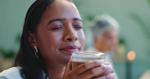 Young woman, happy and coffee at cafe on break, relax and warm beverage for wellness in morning