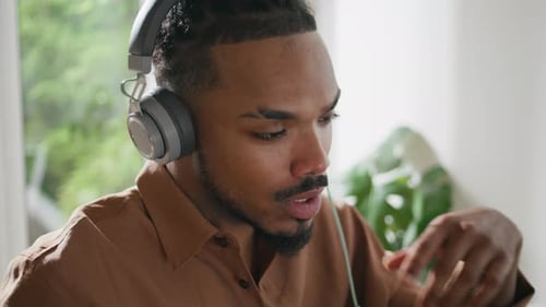 Man Attending Online Meeting Wearing Headphones