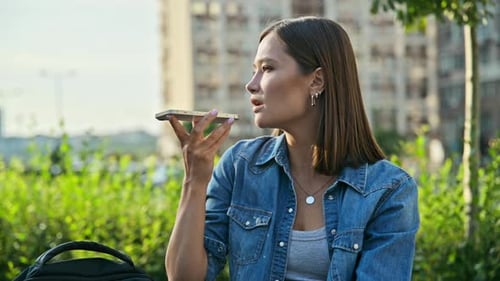 Young Woman Recording Audio Message on Smartphone Outdoors Street Urban Style