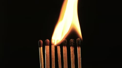 Burning Matches on Black Background