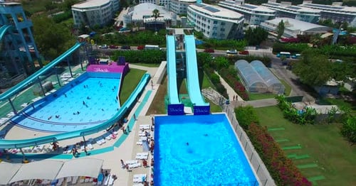 Aerial view of people sliding down a water slide at a water park