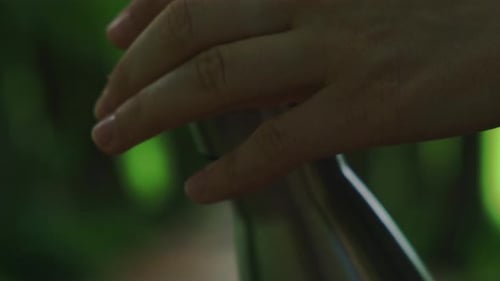 Closeup of Unrecognizable Female Hand Holding Water Bottle