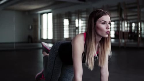 Young woman doing exercise for healthy lifestyle in gym portrait