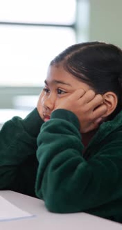Bored, education and quiz with girl in classroom for test, child development and fatigue