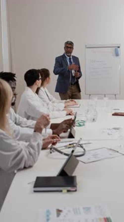 Medical Professionals Attending Lecture in Bright Modern Office