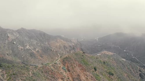 Flight in the clouds in mountains, morning clouds in the mountains aerial, Aerial view above the clo
