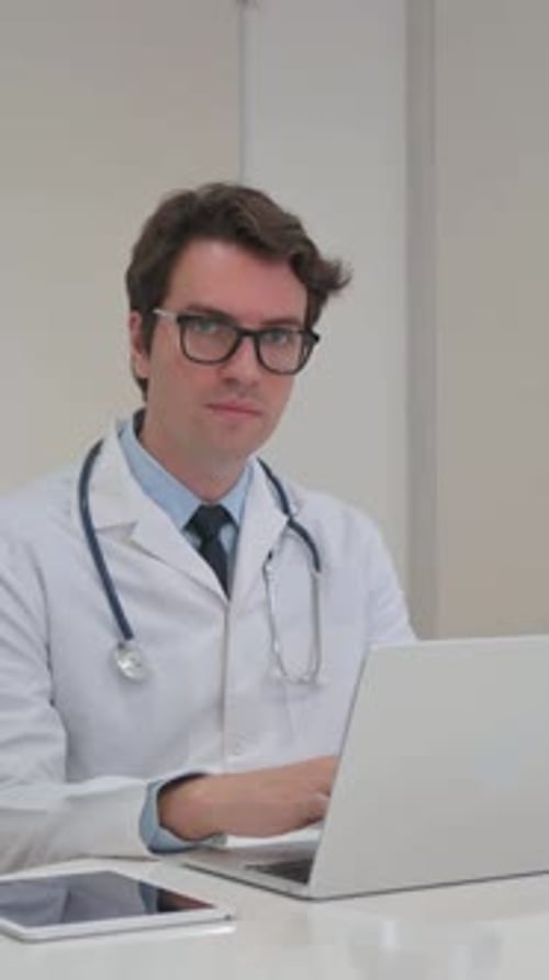 Vertical Video, Young Doctor Smiling at Camera in Clinic