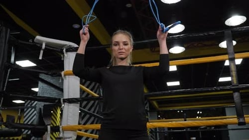 Portrait of a Female Boxer with a Skipping Rope in a Boxing Gym in the Ring
