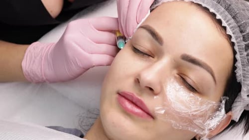 Woman Receiving Cosmetic Injection in Facial Area