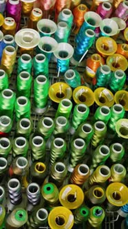 Colorful sewing threads background. Many spools of thread of different colors.