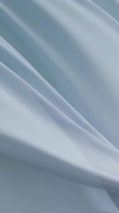 Abstract Light Blue Fabric Waves Flowing Background