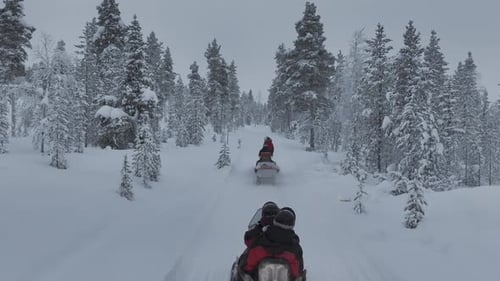 Drone-tracked snowmobile safari in Urho Kekkonen Park in Finland