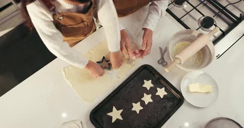 Child and Adult Cutting Star Shapes from Dough