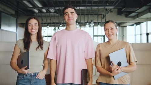 Young IT Professionals Pose Together in a Modern Office Space During a Work Project in the Afternoon