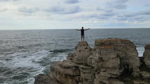 alone man sea rocks