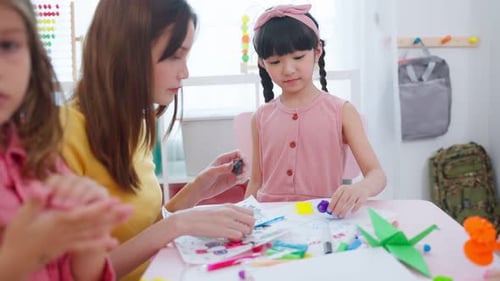 Asian beautiful young woman teacher teaching kids at school.