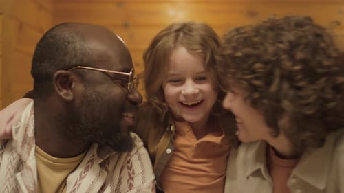 Happy Family Embracing Indoors in Mid Shot