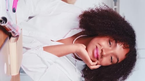 Smiling Young Woman Posing with Curly Hair