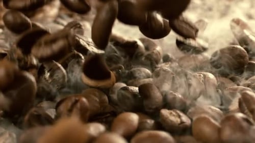Coffee beans are falling close-up