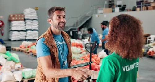 Volunteers Shaking Hands in a Bright Warehouse