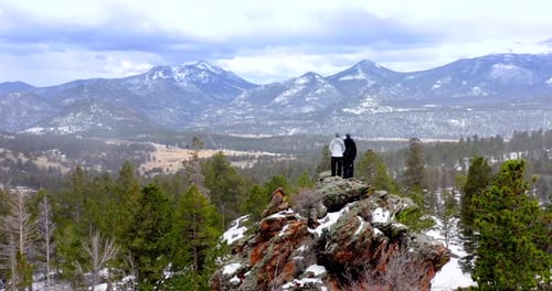 Couple Hiking Rocky Mountain Forest, Rising Aerial Drone Shot