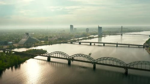 Aerial video of Riga city center, panning cityscape with bridges at sunrise / sunset. 4k footage.