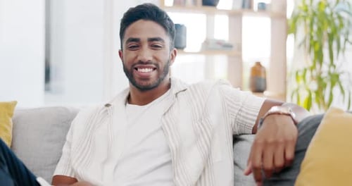 Young Adult Smiling on Couch in Living Room