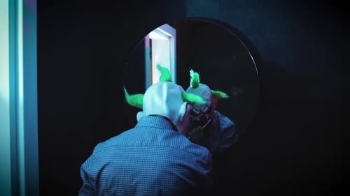 Horror Video of Freaky Man with Clown Mask Brushing Teeth in Dark Bathroom