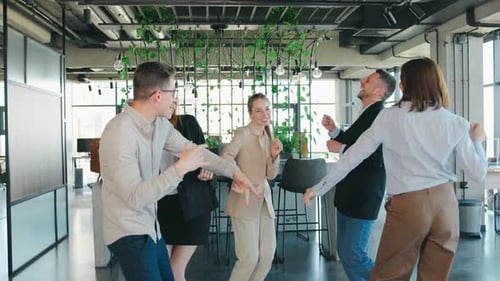 Happy Colleagues Dancing Together in Modern Office
