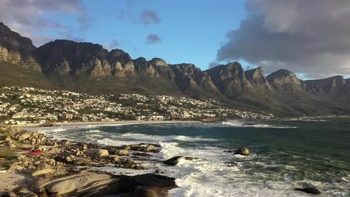 Aerial Stationary Shot of Cape Town's Camps Bay Beach with Table Mountain in the Background at Sunse