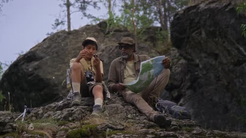 Father and Son Hiking, Navigating with Map and Compass